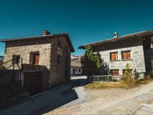 Two stone houses side by side on a sunny day