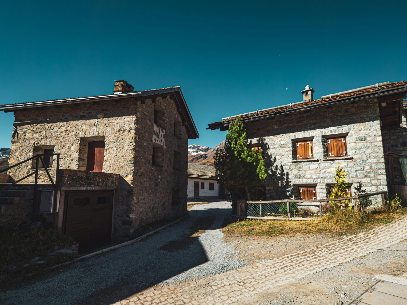 Two stone houses side by side on a sunny day